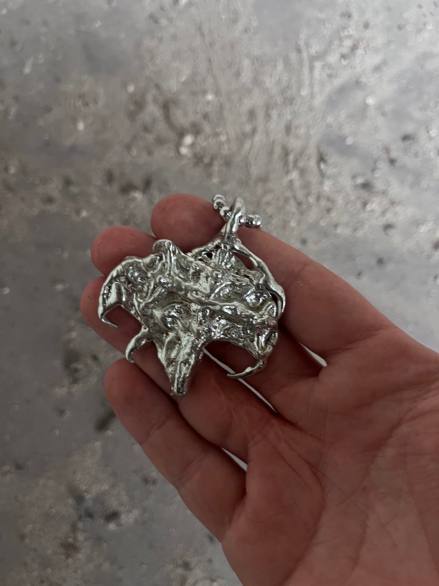 MELTED JESUS PENDANT