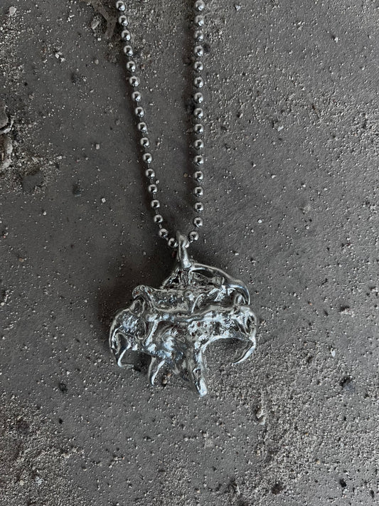 MELTED JESUS PENDANT