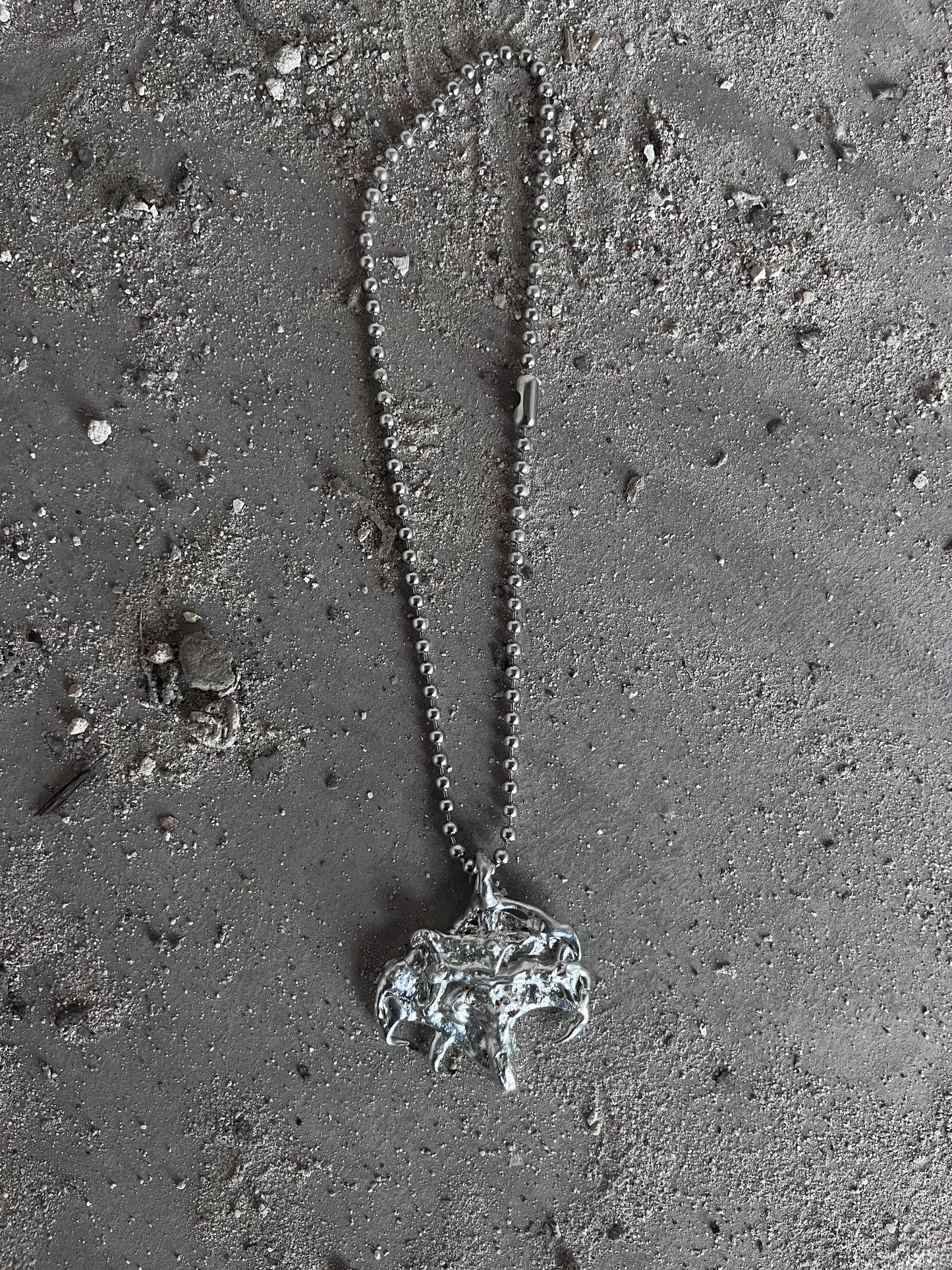 MELTED JESUS PENDANT